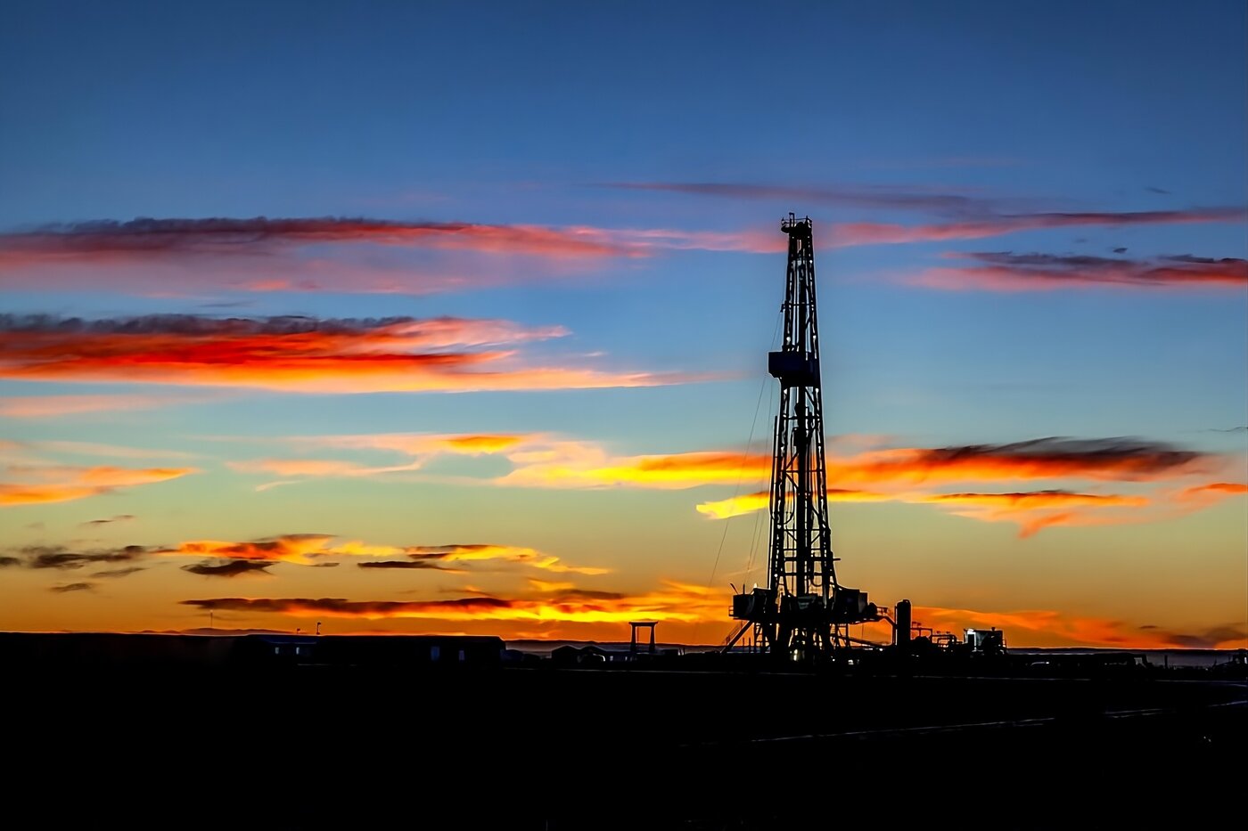 Oil drilling rig at sunset